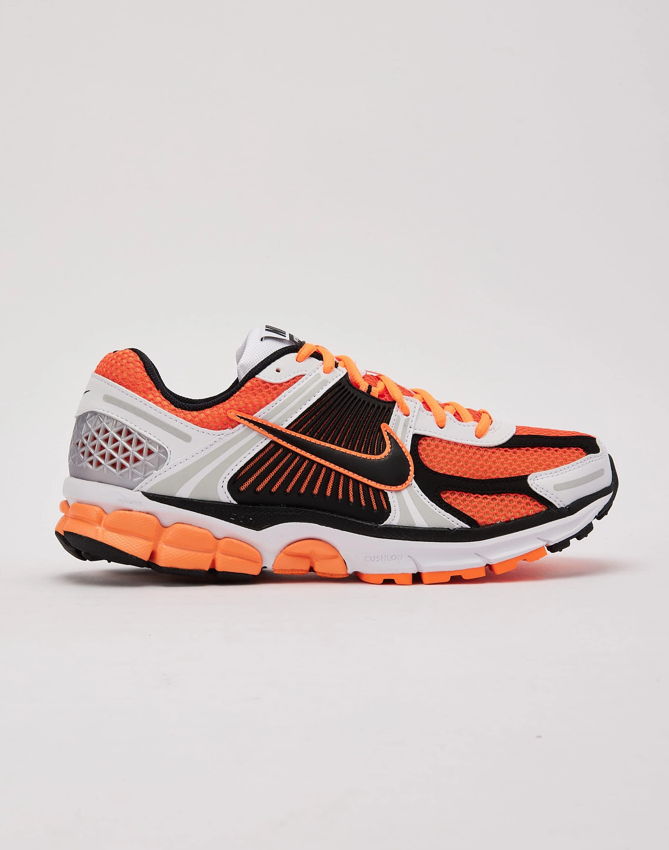 running in a wooden bridge area shoes Nike Zoom Vomero 5